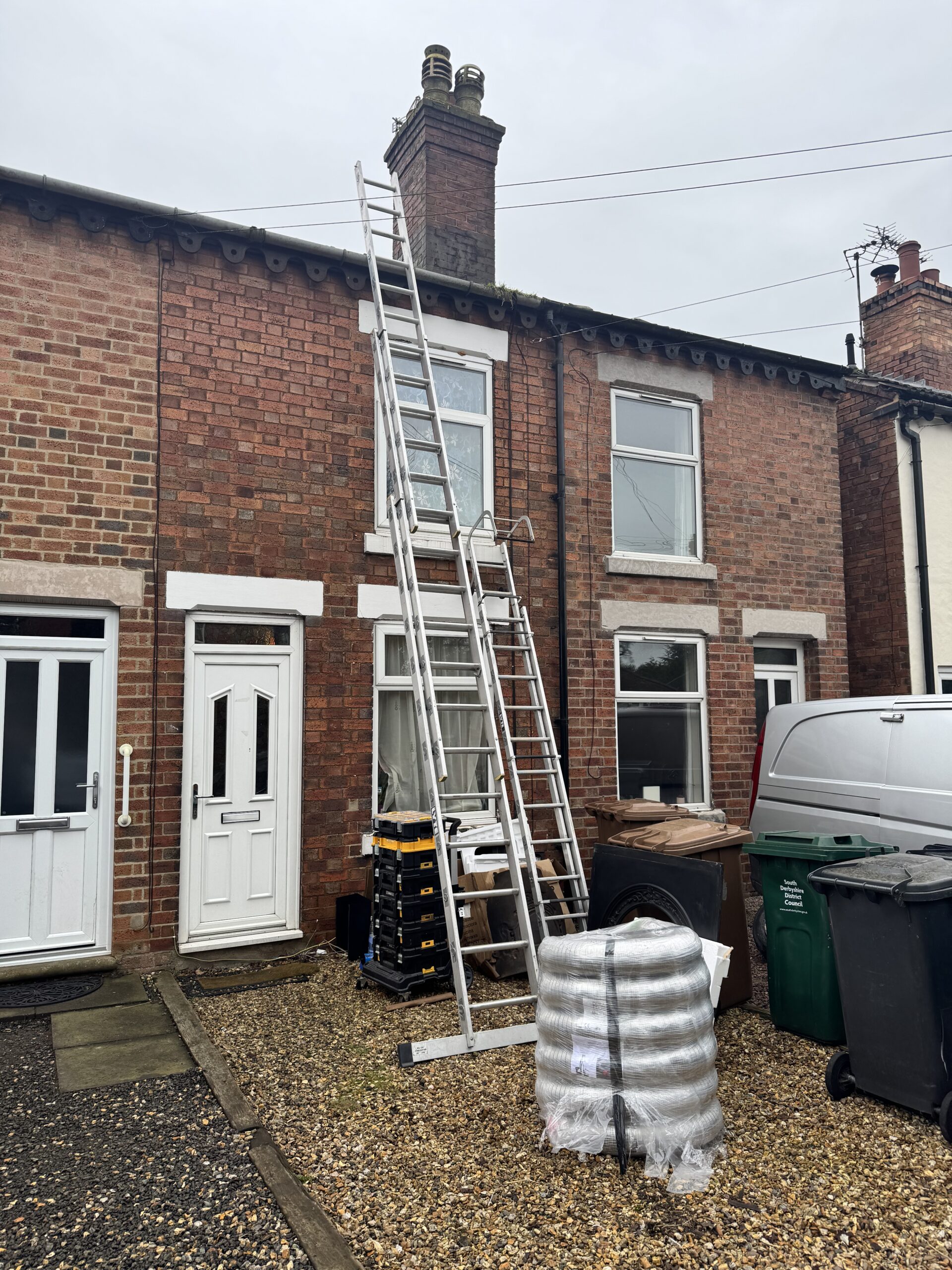 Flexible chimney liner and ladders ready for a liner installation